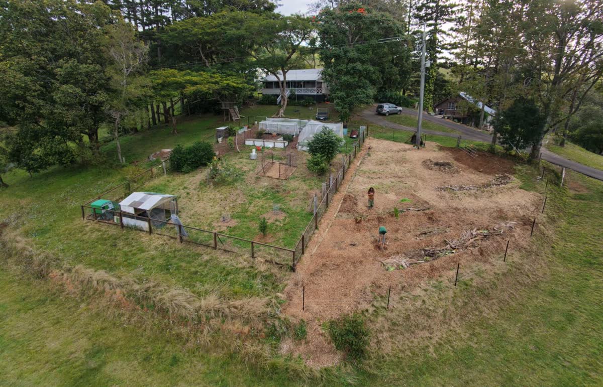 The same aerial view after the work: swales cut and the paddock covered in mulch